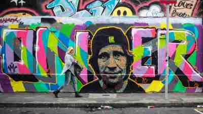 Adult with ADHD walking by a graffiti wall