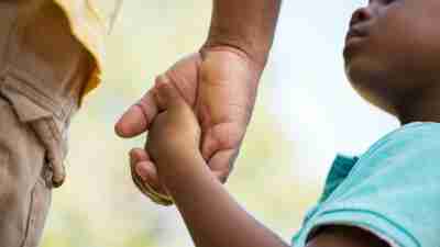 Child holding father's hand