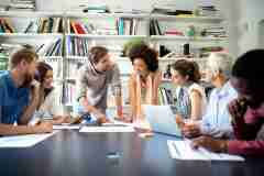 Happiness at workplace: Group of business people at work in office
