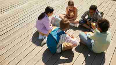 A group of children sitting in a circle, becoming friends