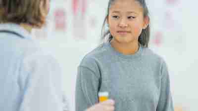 teen girl with ADHD in doctor's office talking about medication